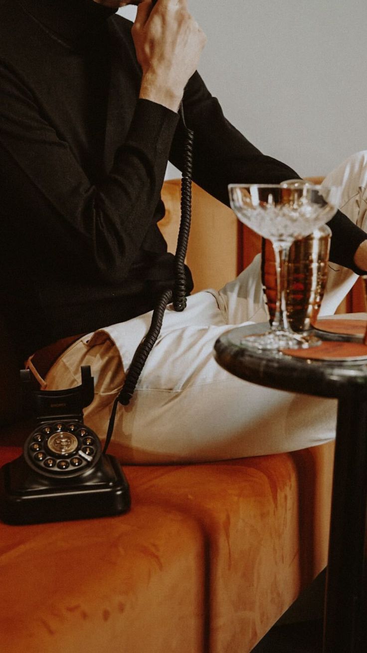 Photo of a man making a phone call in a cozy, vintage living room